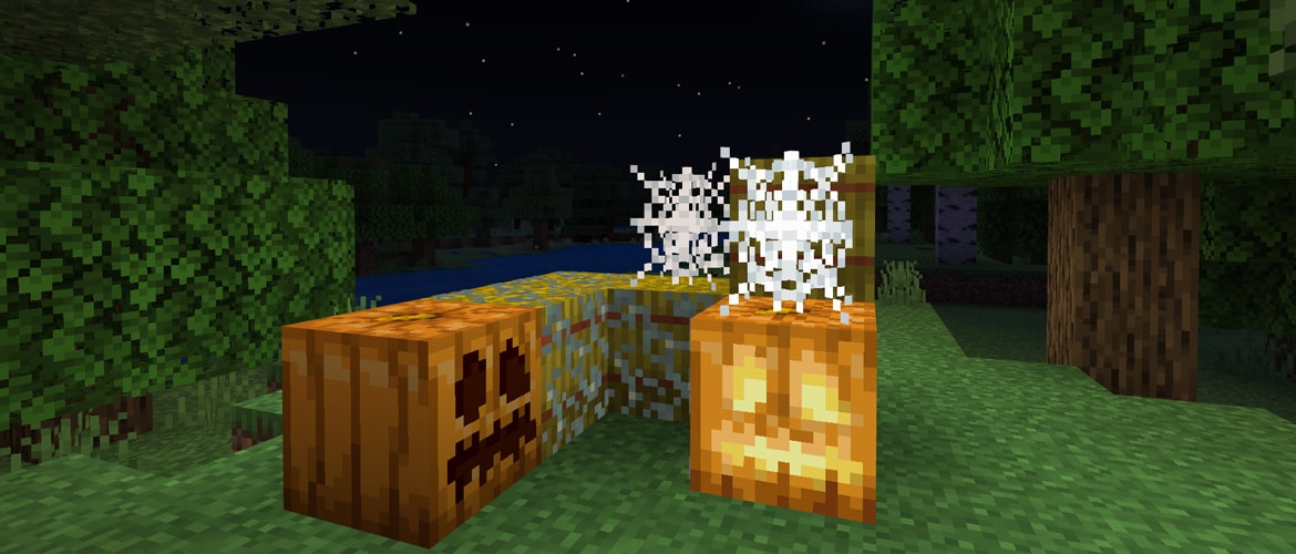 Image in Minecraft of a couple of jack-o-lanterns on some grass surrounded by a couple of cobwebs and some trees at night