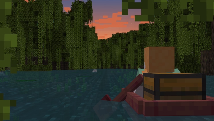 Alex sitting in a boat with a chest in a mangrove swamp