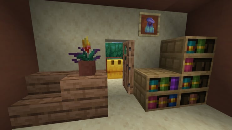 A room with a potted Torchflower, Chiseled Bookshelves and a Pitcher Plant in an item frame. A Sniffer is lurking outside the open door.