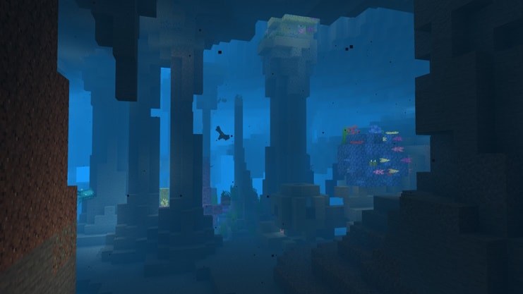 The silhouette of a player swimming down to an ocean ruin.