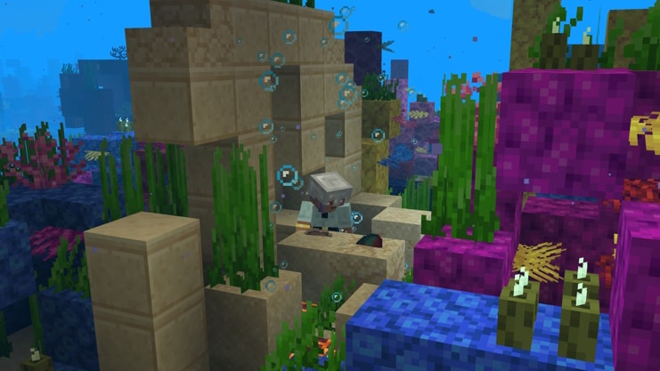 A player is brushing suspicious sand in an Ocean Ruin located inside a reef. A sniffer egg is starting to appear from the sand.