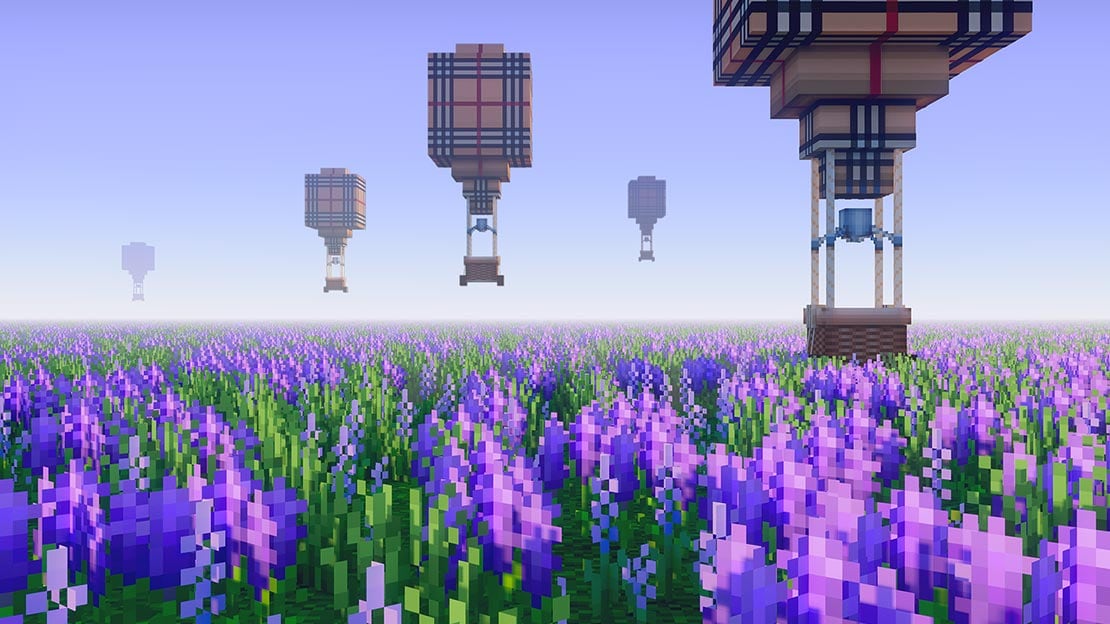 Wallpaper showing Burberry patterned hot air balloons over a field of purple flowers